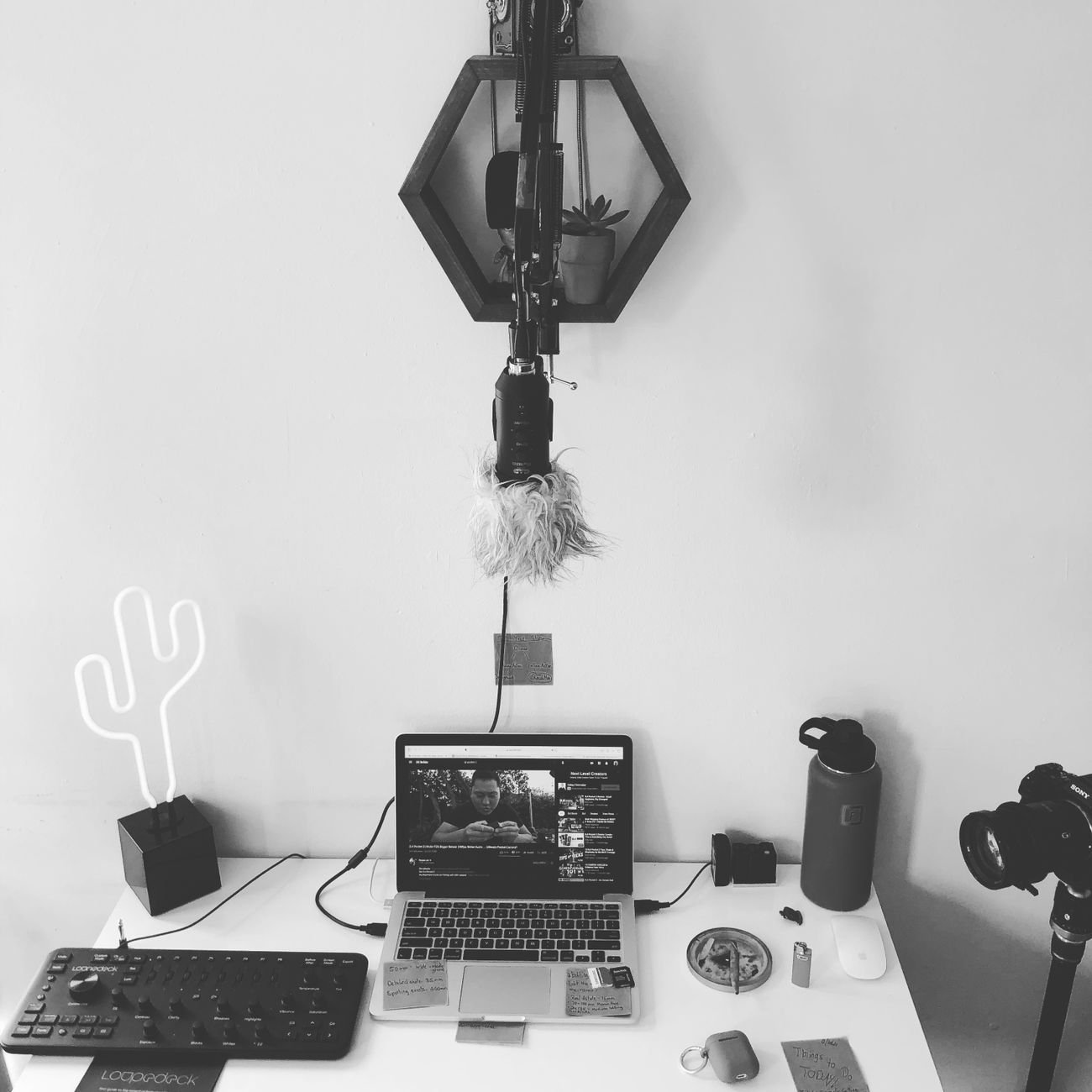 A minimalist home recording studio setup with a laptop and creative equipment.
